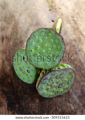 Lotus seeds on old wood background.