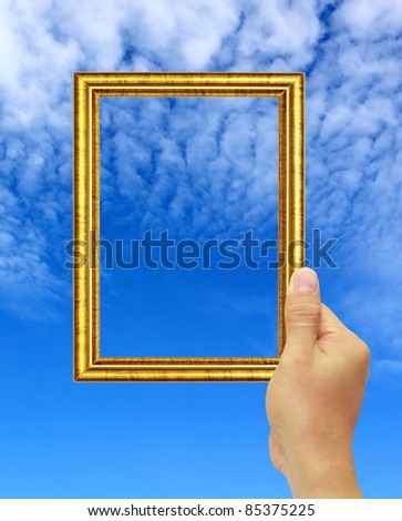 hand hold a gold photo frame