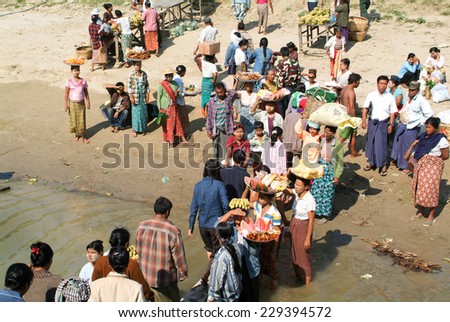River Ayeyarwady, Myanmar - 20 January 2010: People selling food on the Ayeyarwady river bank, Myanmar