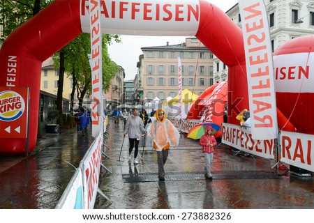 Lugano, Switzerland 26 April 2015: People at the finish line under the rain during the walking contest of Lugano on Switzerland