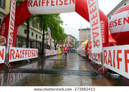Lugano, Switzerland 26 April 2015: People at the finish line under the rain during the walking contest of Lugano on Switzerland