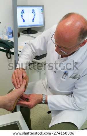 Locarno, Switzerland: 4 May 2010: Doctor preparing orthopedic insoles for a patient on his studio