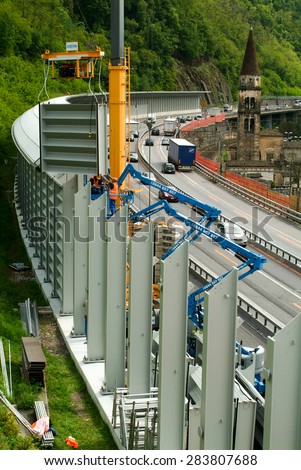 Bissone, Switzerland - 12 May 2010: Workers during the installation of noise barriers on the highway at Bissone on Switzerland
