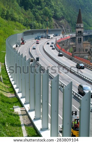 Bissone, Switzerland - 29 April 2010: Workers during the installation of noise barriers on the highway at Bissone on Switzerland