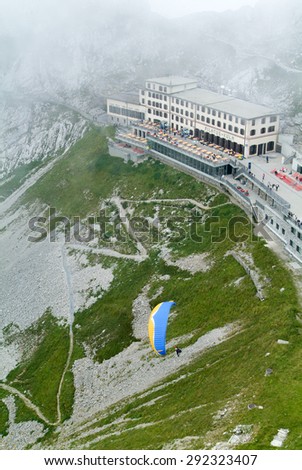 Mount Pilatus, Switzerland - 23 August 2006: person flying with a parapent at Pilatus Kulm station near the summit of Mount Pilatus on the alps of central Switzerland