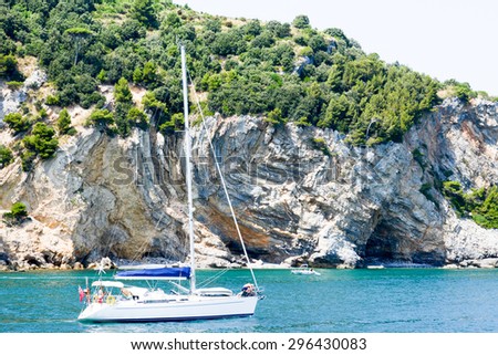 Portovenere, Italy - 7 July 2015: People sailing with a sailboat in front of Palmaria island near Portovenere on cinque terre, Italy