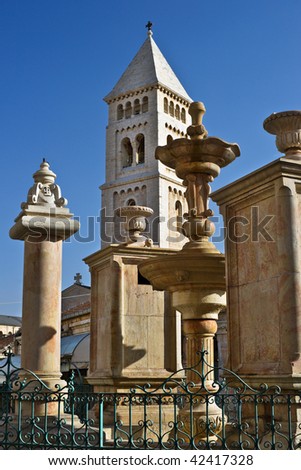 Fountain at small square in the Old City of Jerusalem and bell tower of Lutheran church of the Transfiguration, Israel