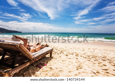 Relaxing and reading on the beach. Thailand