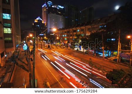BANGKOK, THAILAND - JULY 30, 2007: Night scenery of one of the central streets of Bangkok. In the centre of Bangkok heavy traffic does not stop even at night.