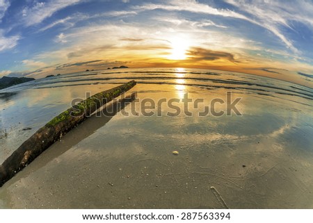 Tropical beach at beautiful sunset in fish-eye lense. Nature background