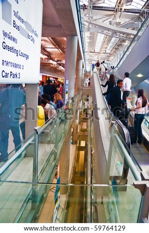 BANGKOK - OCTOBER 5: Passengers move on the escalator at Suvarnabhumi International Airport on October 5, 2006 in Bangkok. The airport is 18th busiest in the world (by passenger traffic).