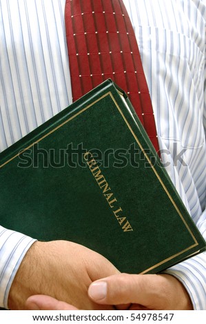 lawyer holding criminal law book , law concept , justice concept
