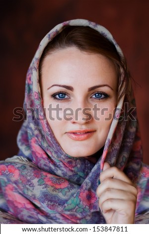 Portrait of  beautiful young woman in  Russian scarf/Portrait in  Russian style