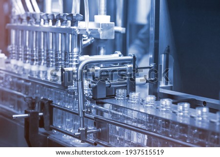 Liquid filling and bottle capping machine for industry. Beverage factory use automation and process instument for automatic of bottle cleaning, filling and capping machine in line production.