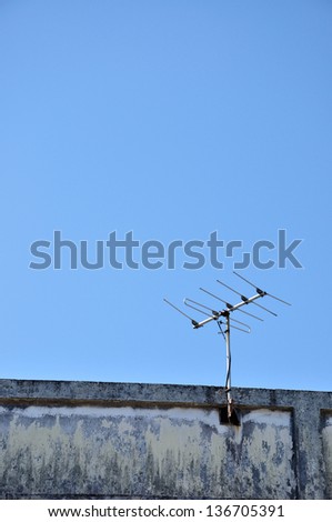 Old technology of TV antenna on residence roof.
