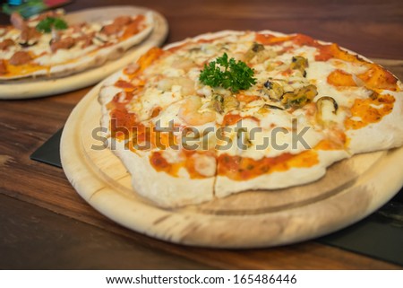 Seafood pizza produces from wood fired oven.