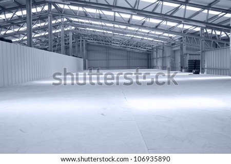 Huge gray and light warehouse with metal roof