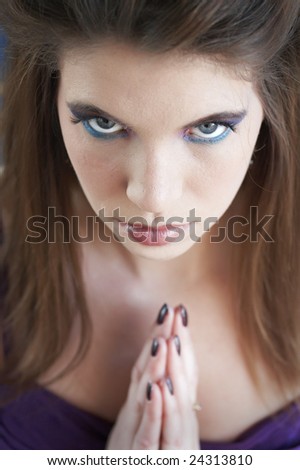 a picture of a female praying while looking ahead