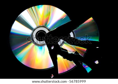 Broken CD disk on the black background