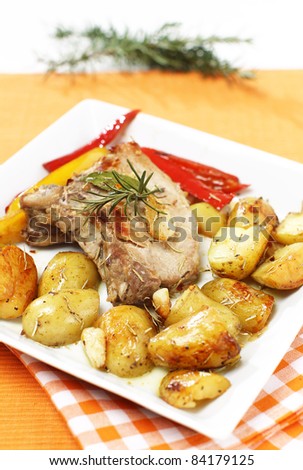 Delicious pork chops baked with potatoes and rosemary