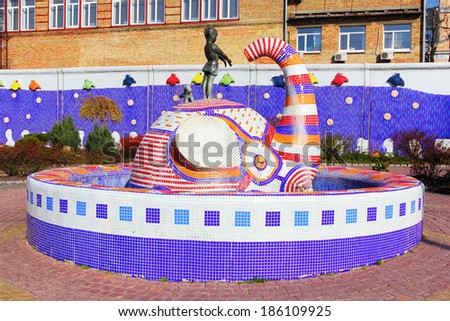 KIEV, UKRAINE - APRIL 3, 2014: The playground on Landscape Valley made by Konstantin Skretutskiy with an artistic fountain with an elephant, a girl and a dog, on April 3 in Kiev.