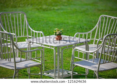 White garden furniture on green grass