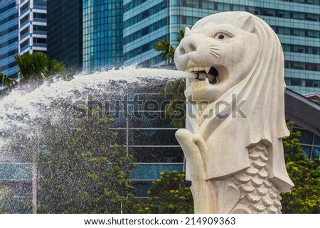 SINGAPORE - AUG 30: The Merlion fountain in front of the Marina Bay Sands hotel on August 30, 2014 in Singapore. Merlion is a imaginary creature with the head of a lion, seen as a symbol of Singapore