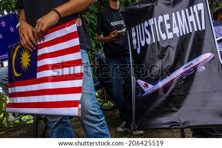 KUALA LUMPUR - JULY 22, 2014: Protesters waving placards and demanding justice for victims of the Malaysia Airlines flight that was shot down over Ukraine last week infront the Russian Embassy.