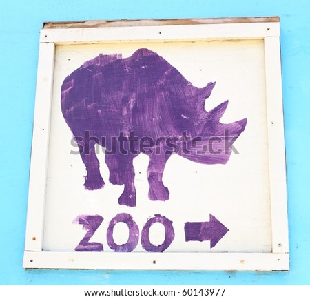 purple stencil painted sign that says zoo