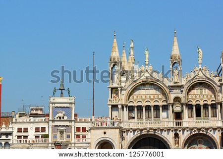 VENICE, ITALY - AUGUST 21: Saint Mark's Basilica on August 21, 2012 in Venice, Italy. On the left Saint Mark's Clocktower and its astronomical clock.