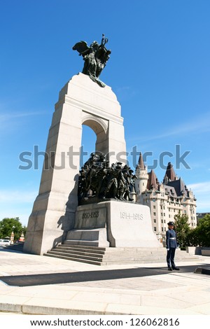 OTTAWA, CANADA - AUGUST 8: National War Memorial on August 8, 2008 in Ottawa, Canada. The monument is composed of 23 bronze figures and a stone arch. In the background the Chateau Laurier Hotel.