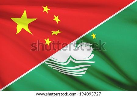 Flags of China and Macao Special Administrative Region of the People\'s Republic of China blowing in the wind. Part of a series.