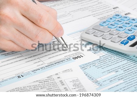 Tax Form 1040 - man filling out tax form