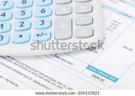 Calculator over utility bill - studio shot