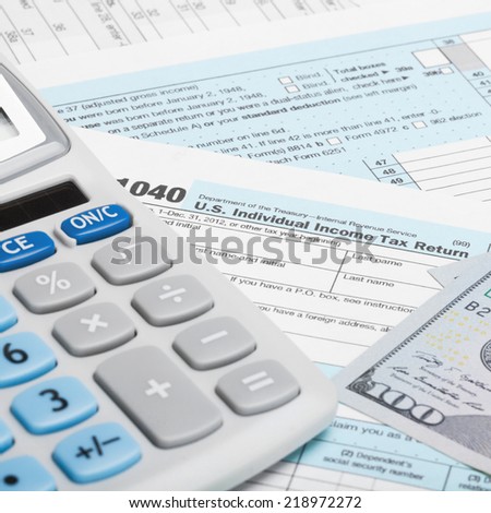 US Tax Form 1040 with calculator and US dollars - 1 to 1 ratio