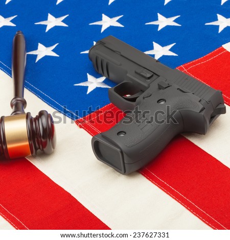 Judge gavel and gun over USA flag - self-defense law concept