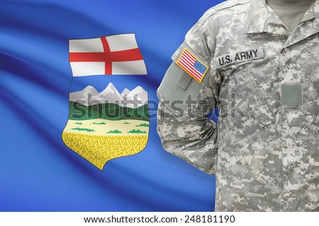 American soldier with Canadian province flag on background - Alberta