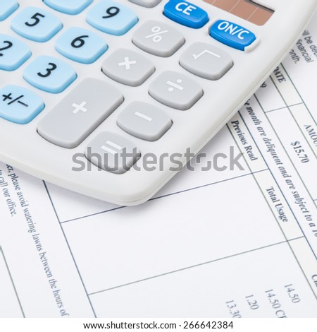 Neat calculator with utility bill under it - close up shot