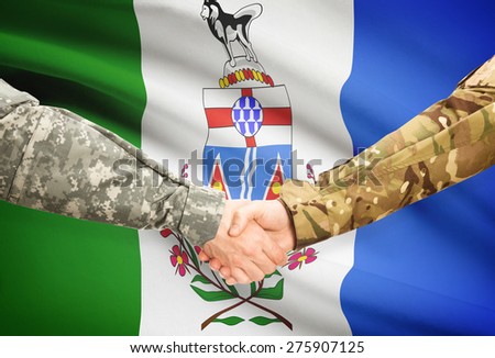 Soldiers handshake and Canadian province flag - Yukon