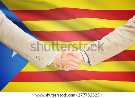 Businessmen shaking hands with flag on background - Estelada - Spain
