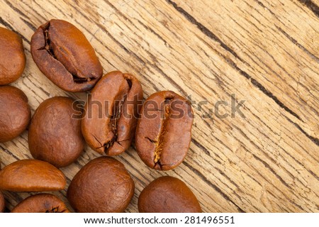 Roasted coffee beans on wooden table - close up studio shot
