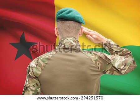 Soldier in hat facing national flag series - Guinea-Bissau