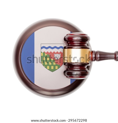 Wooden judge gavel with Canadian province flag on sound block - Northwest Territories