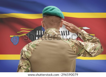 Dark-skinned soldier in hat facing national flag series - Swaziland