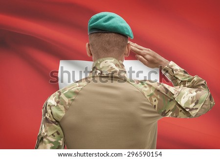 Dark-skinned soldier in hat facing national flag series - Switzerland