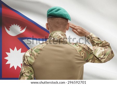Dark-skinned soldier in hat facing national flag series - Nepal