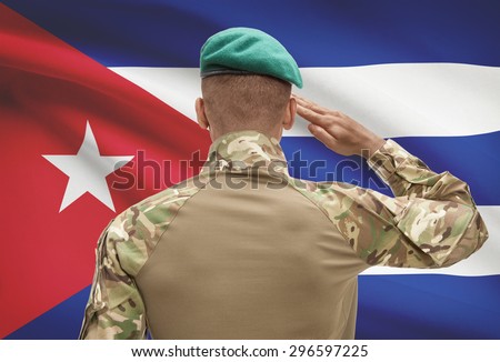 Dark-skinned soldier in hat facing national flag series - Cuba