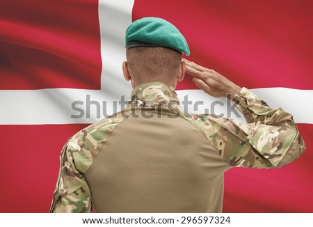Dark-skinned soldier in hat facing national flag series - Denmark