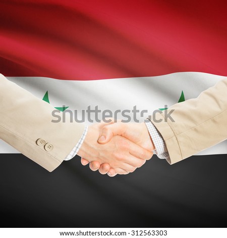 Businessmen shaking hands with flag on background - Syria