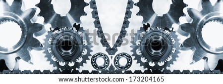 gears and cogwheels of titanium and steel powered by a timing-chain, panoramic view
